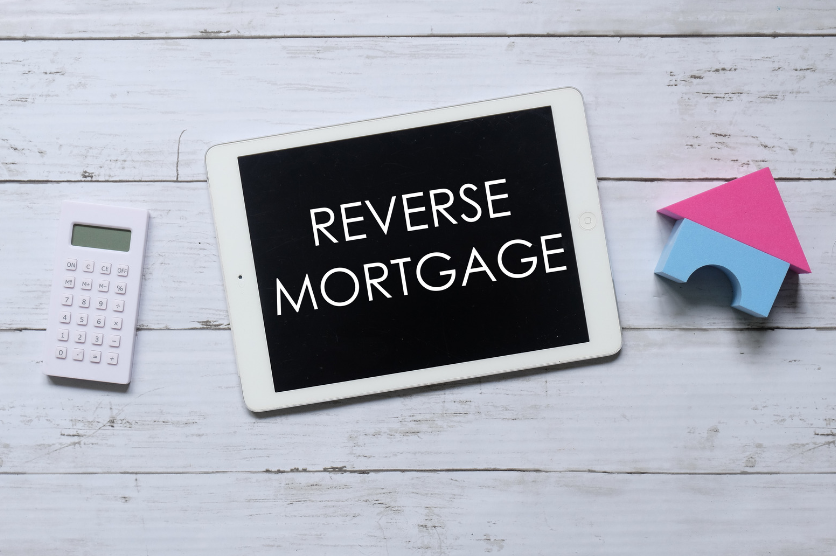 A tablet with the words reverse mortgage written on it