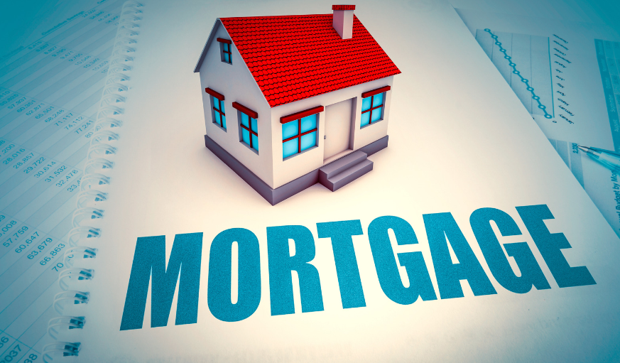 A small house is sitting on top of a piece of paper that says mortgage.