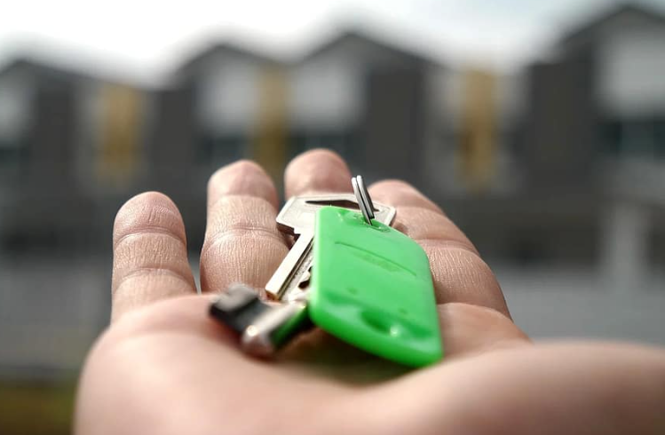 A person is holding a bunch of keys in their hand.