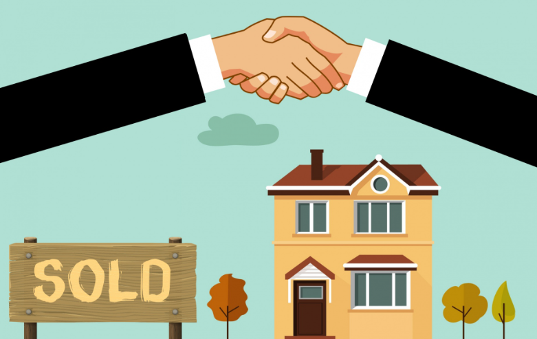 Two people shaking hands in front of a sold sign