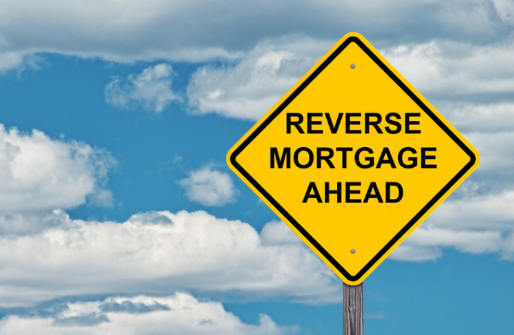 A yellow sign that says reverse mortgage ahead