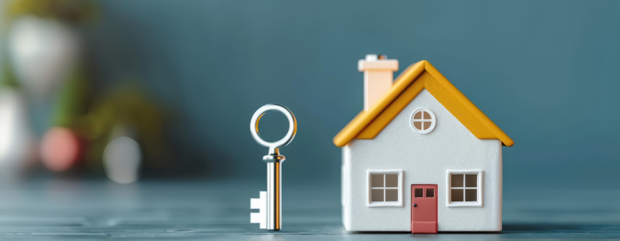 A small house with a key in front of it.