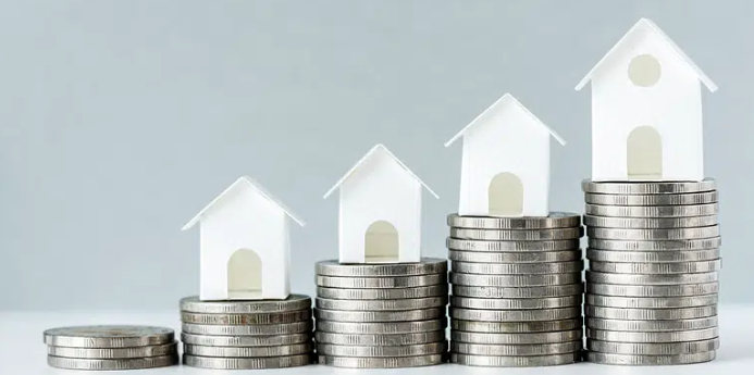 A stack of coins with houses on top of them.