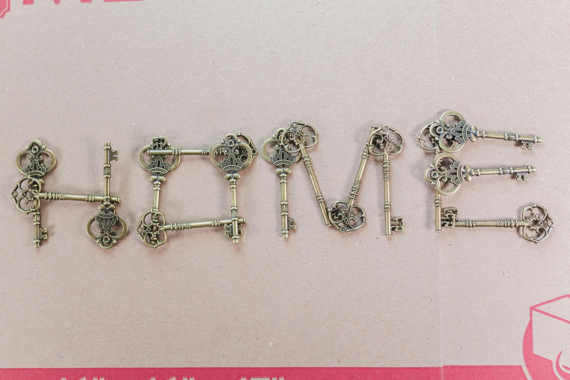 The word home is made out of keys on a pink background