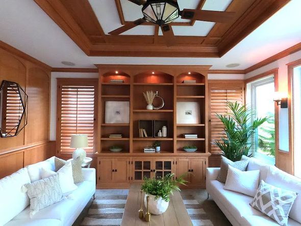 Wooden kitchen cabinets with countertop and a refrigerator.