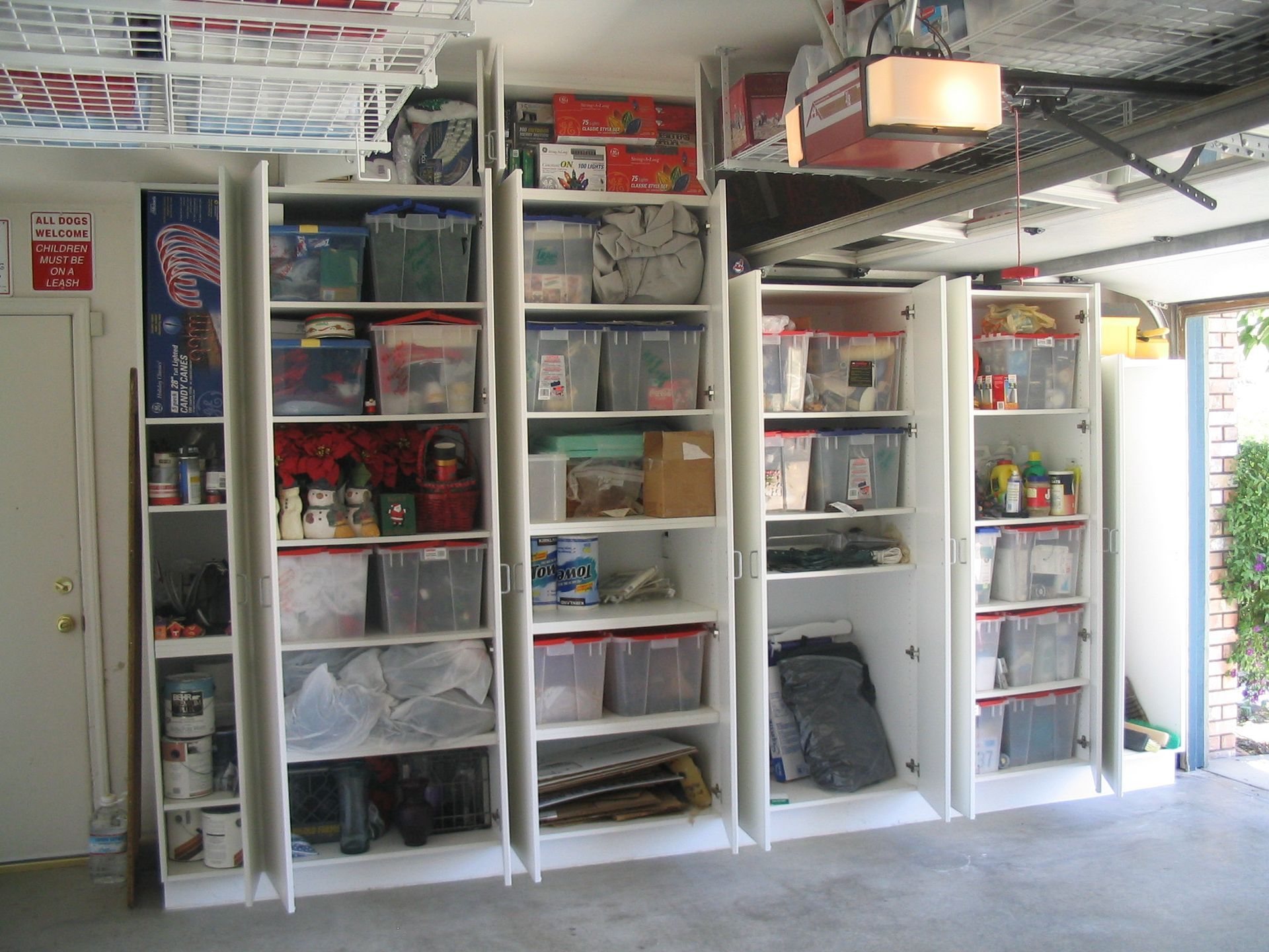 Garage storage cabinets filled with boxes and items.