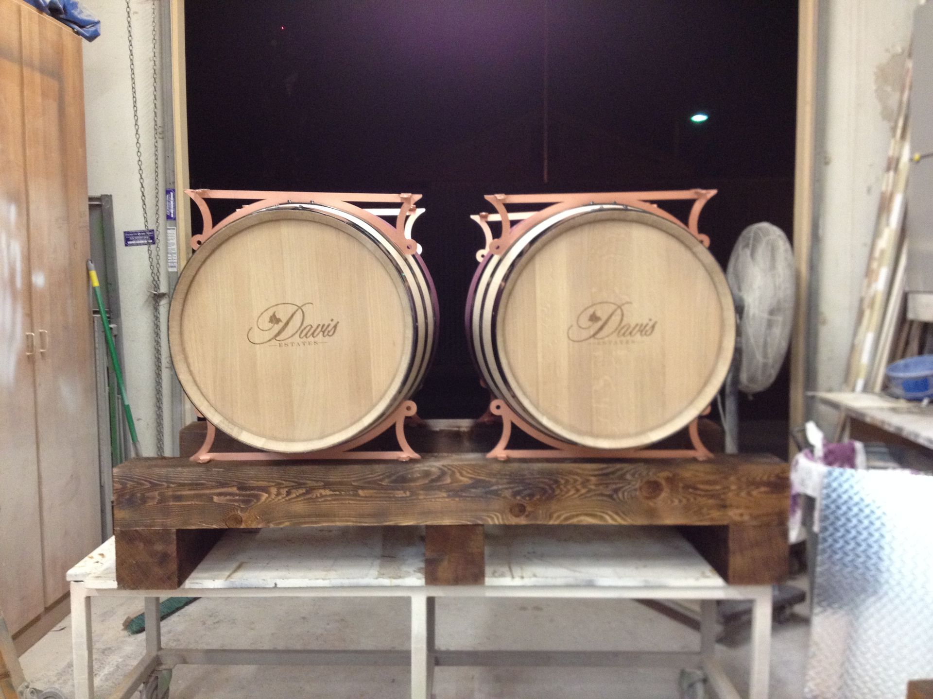 Two wooden barrels with copper supports, each with 
