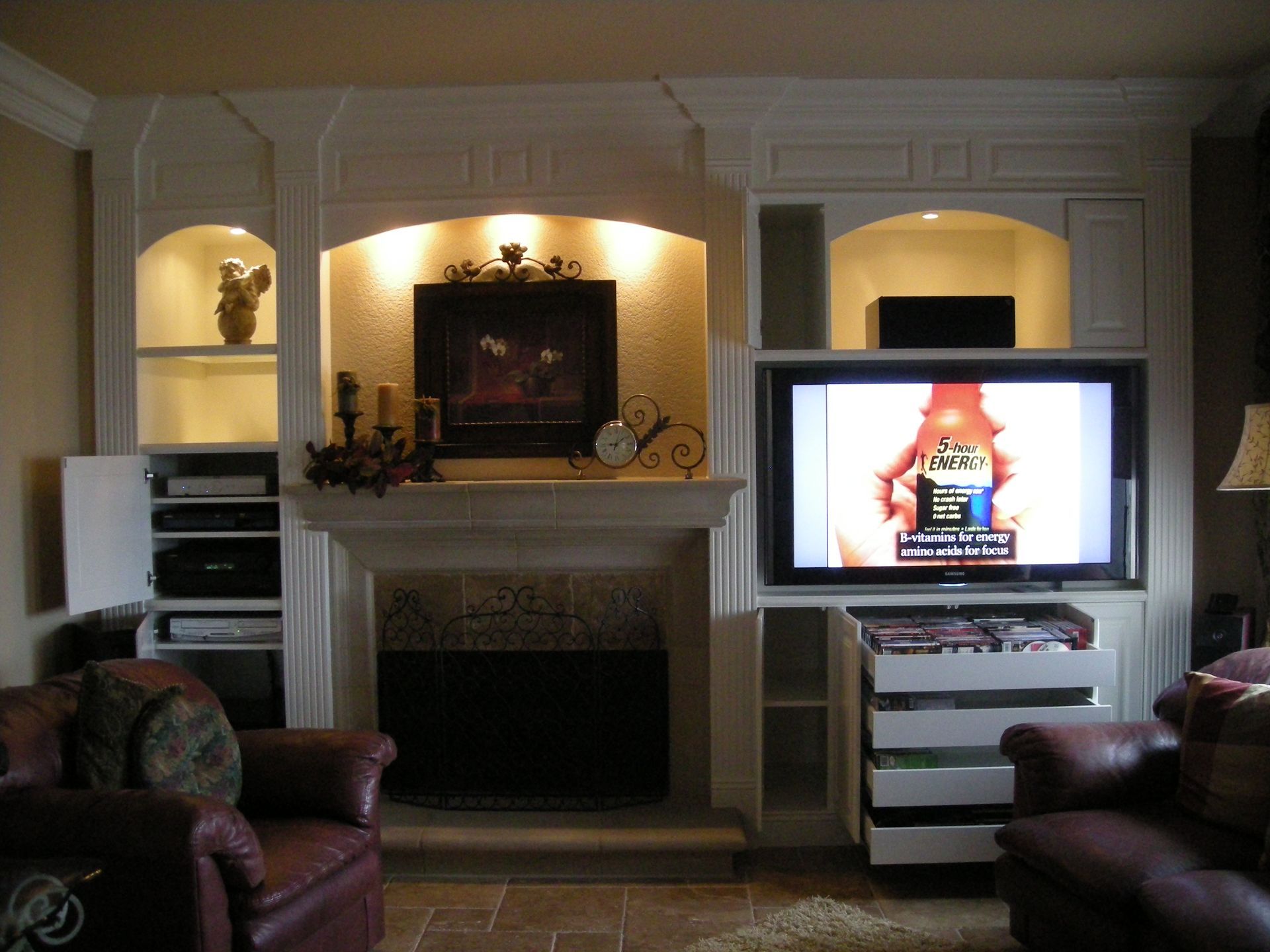 Fireplace with TV and built-in shelving in a living room.