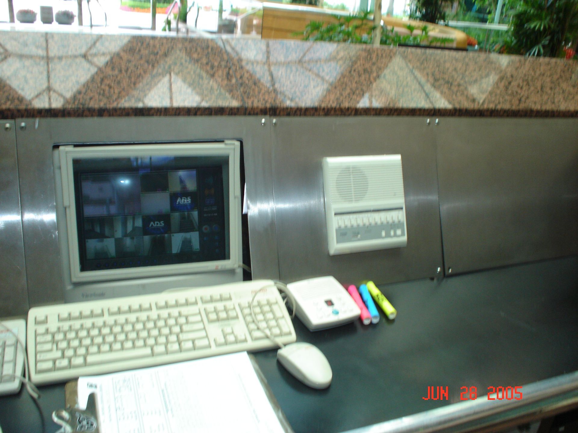 A control panel with a computer screen, keyboard, speaker, and colorful markers.