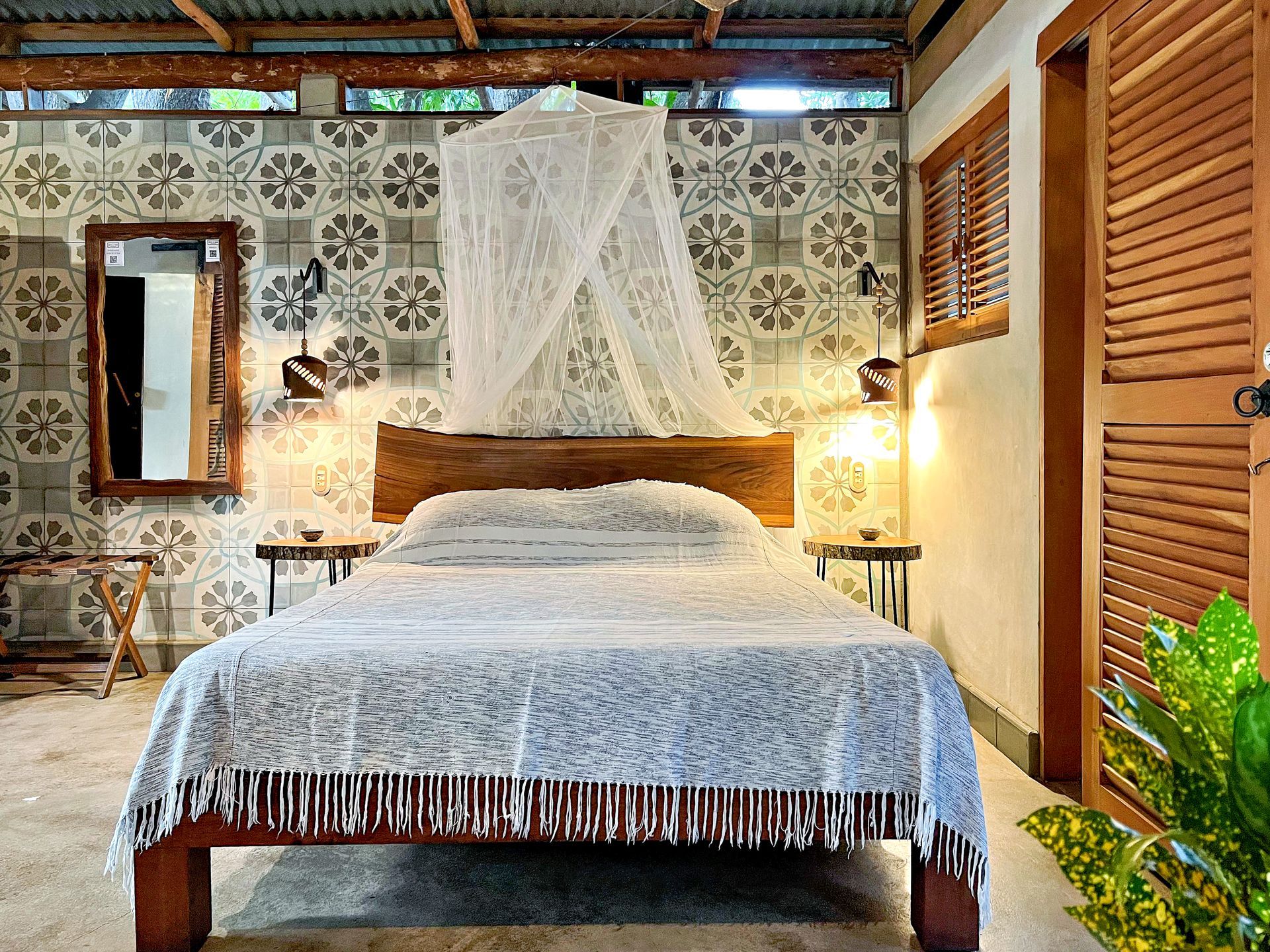 A bedroom with a bed and a sliding door.