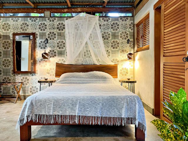 A bedroom with a bed and a sliding door.