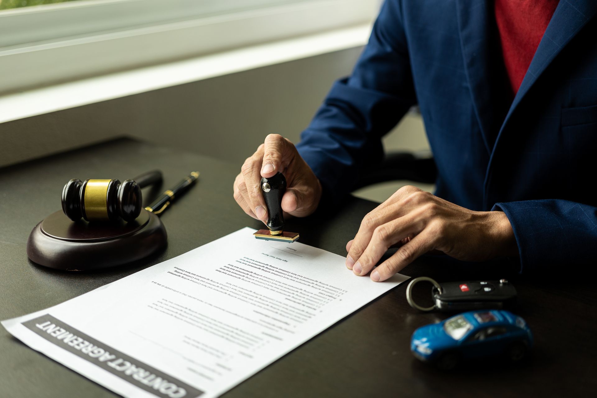 A man is stamping a contract. A man is stamping a contract.
