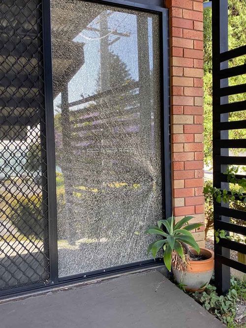 A Balcony With Sliding Glass Doors and Trees in the Background  — Reflect Glass In Tuggerah, NSW