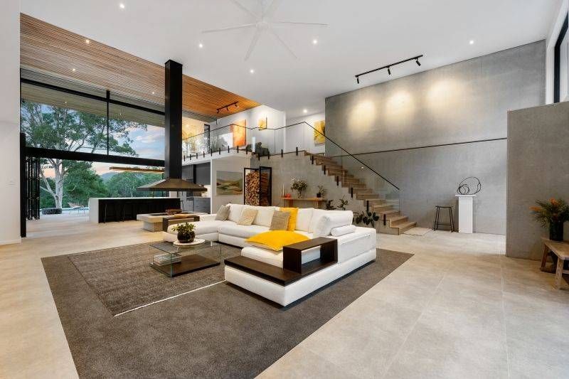 A Wooden Staircase With a Glass Railing in a Hallway — Reflect Glass In Tuggerah, NSW