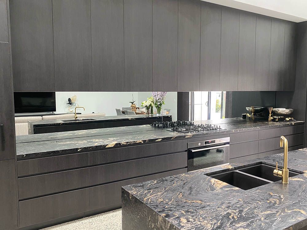 A Kitchen With a Sink, Stove, Cabinets and a Large Mirror — Reflect Glass In Kincumber, NSW