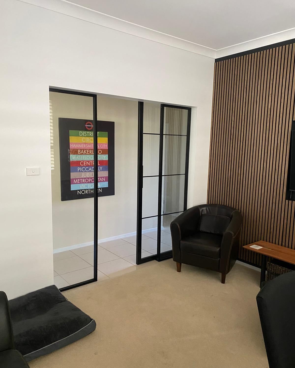 A Living Room With a Couch, Chair, Table and Television — Reflect Glass In Tuggerah, NSW