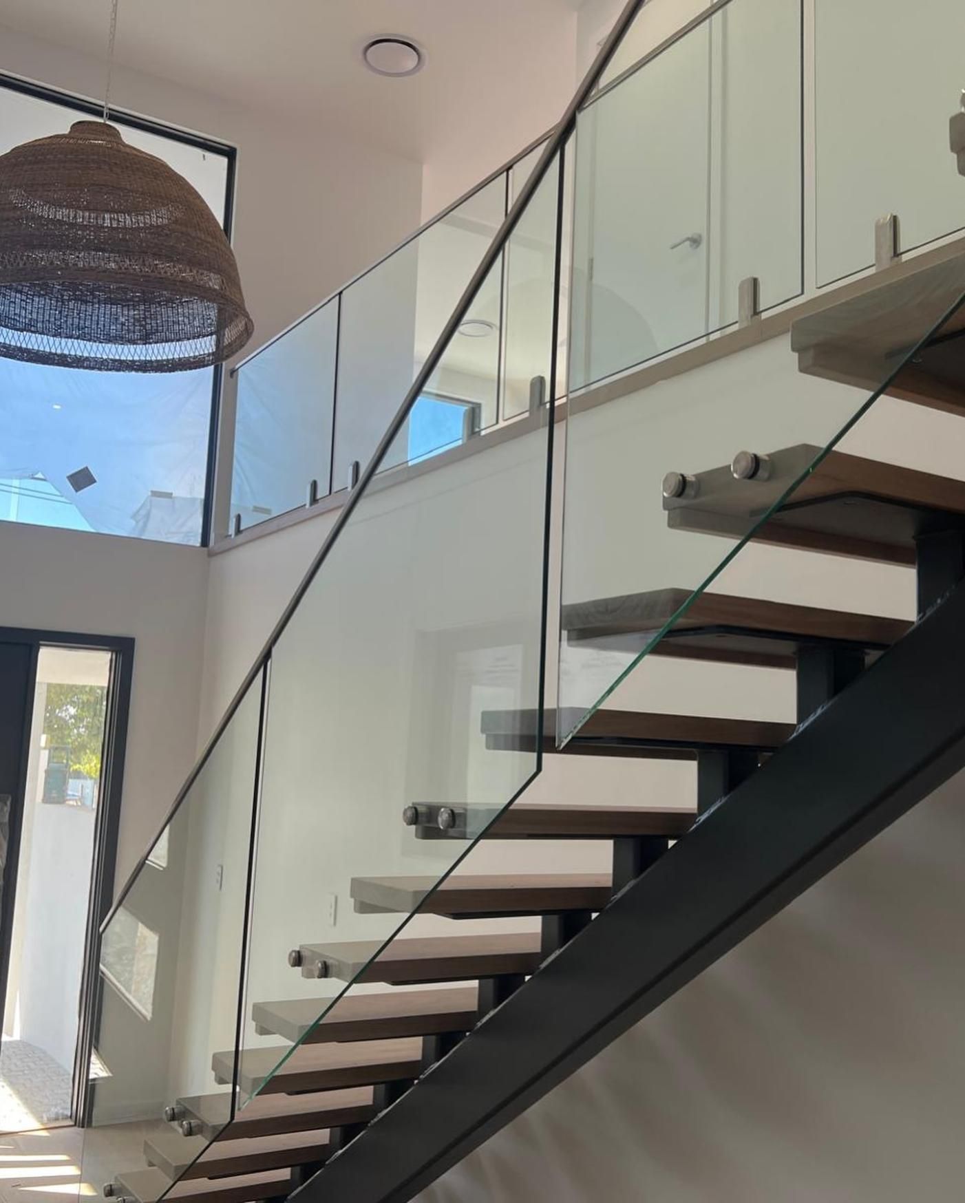 A Staircase With a Glass Railing and Wooden Steps — Reflect Glass In Tuggerah, NSW