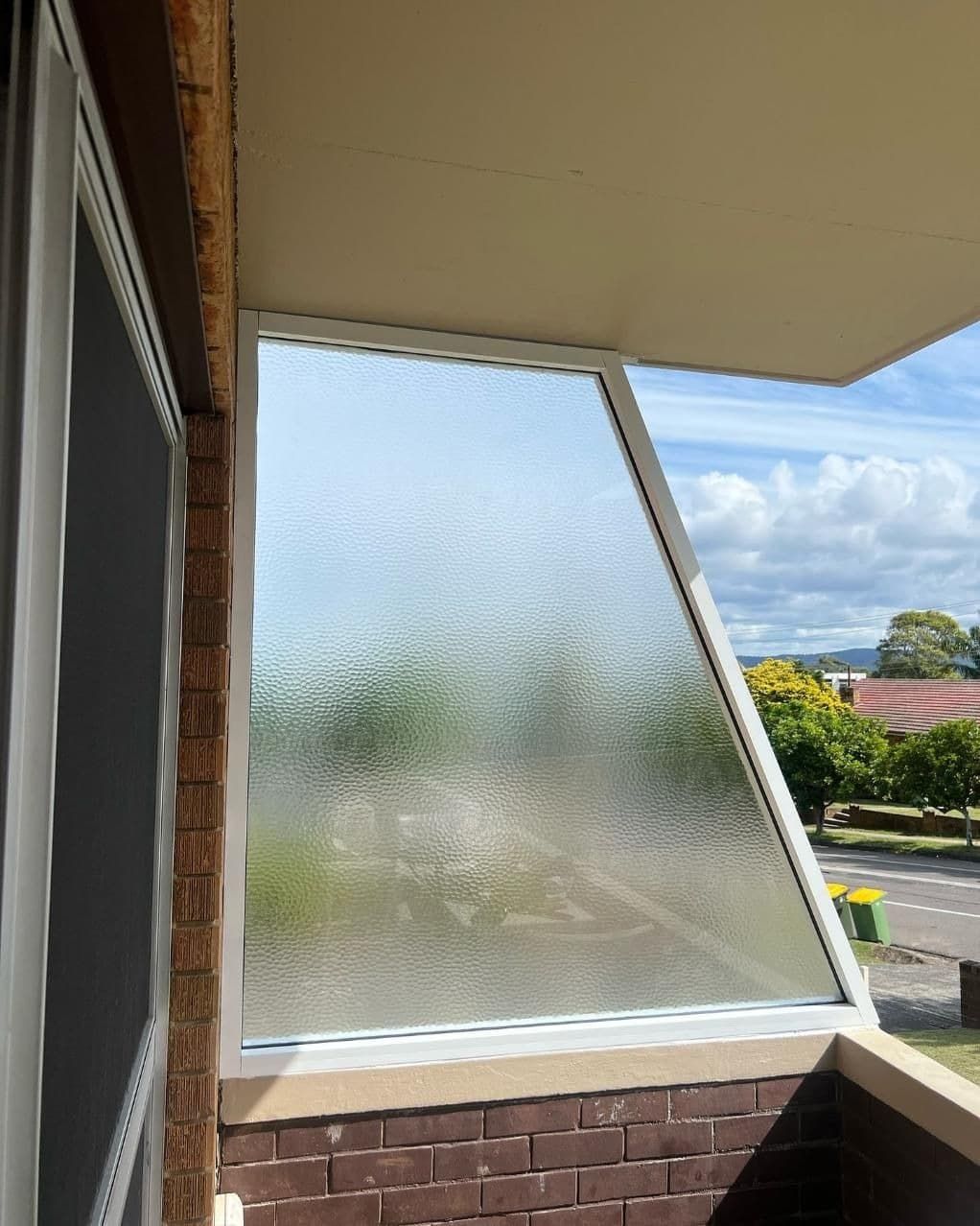 A Balcony With a Glass Window and a Brick Wall — Reflect Glass In Tuggerah, NSW