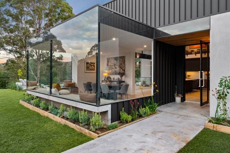A Balcony With a Couch and a Table in Front of a House — Reflect Glass In Tuggerah, NSW