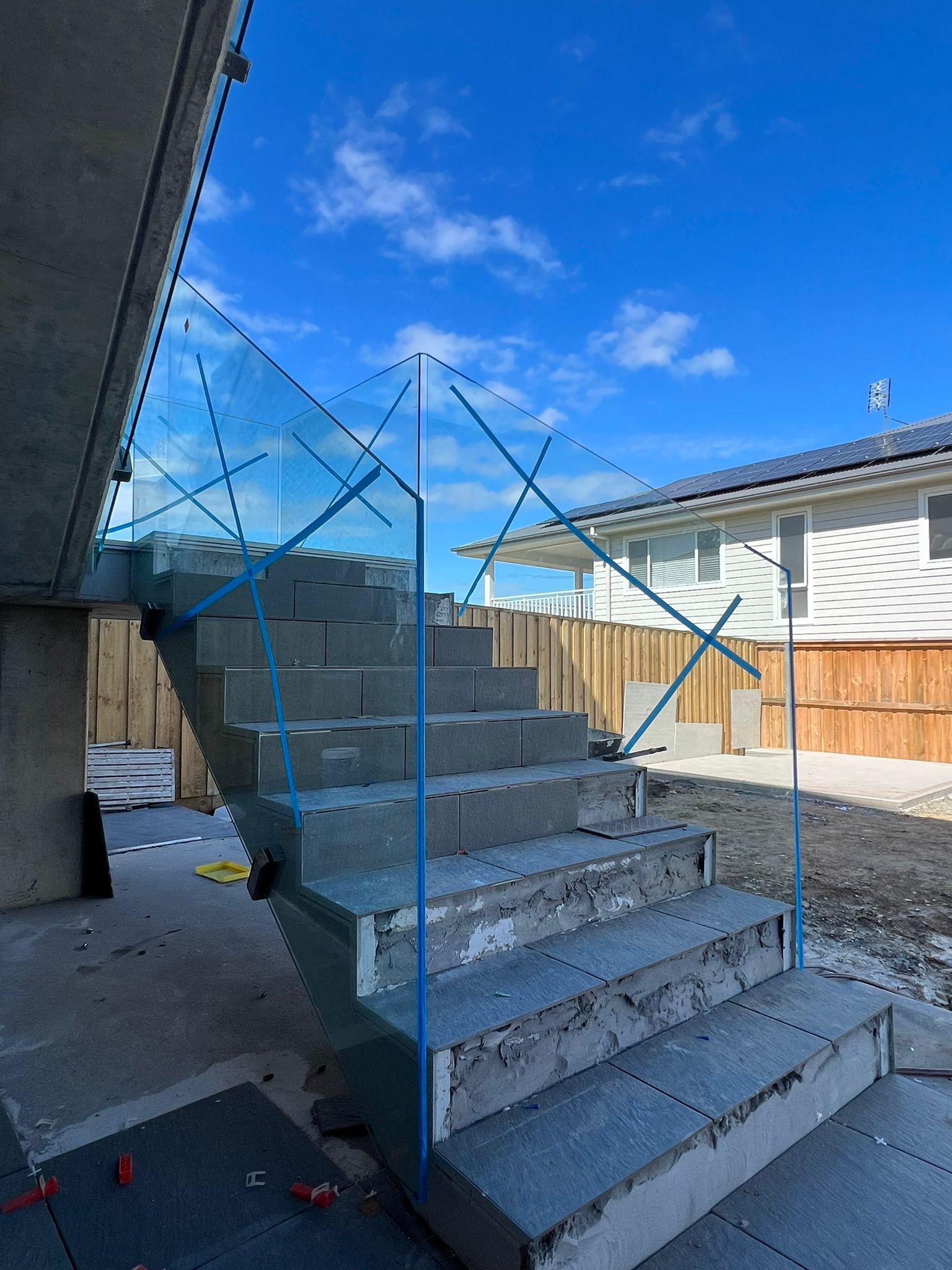 A Balcony with A Glass Railing and Stainless Steel Railing — Reflect Glass In Newcastle, NSW