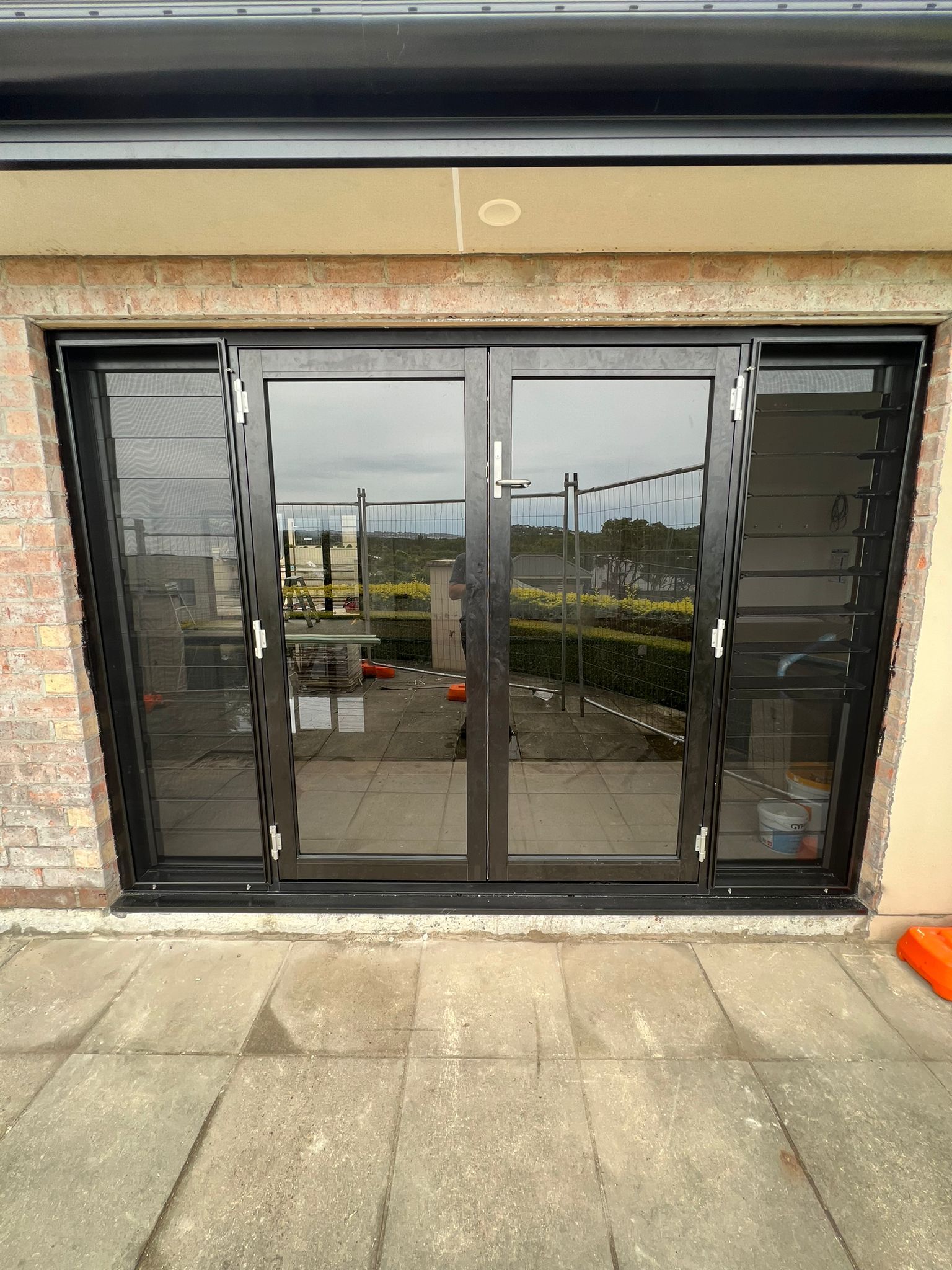 A Hallway With Sliding Glass Doors and Frosted Glass Walls — Reflect Glass In Tuggerah, NSW