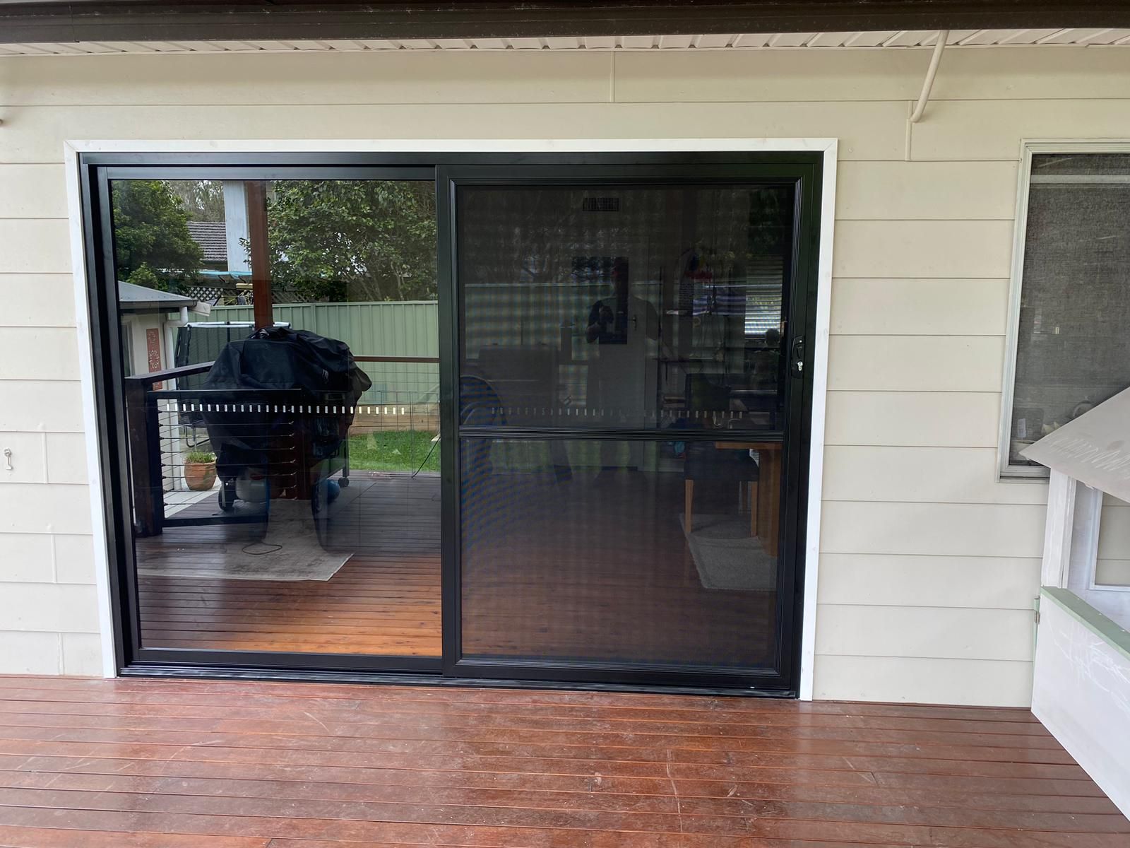 A White House With a Sliding Glass Door and a Balcony — Reflect Glass In Hunter Valley, NSW