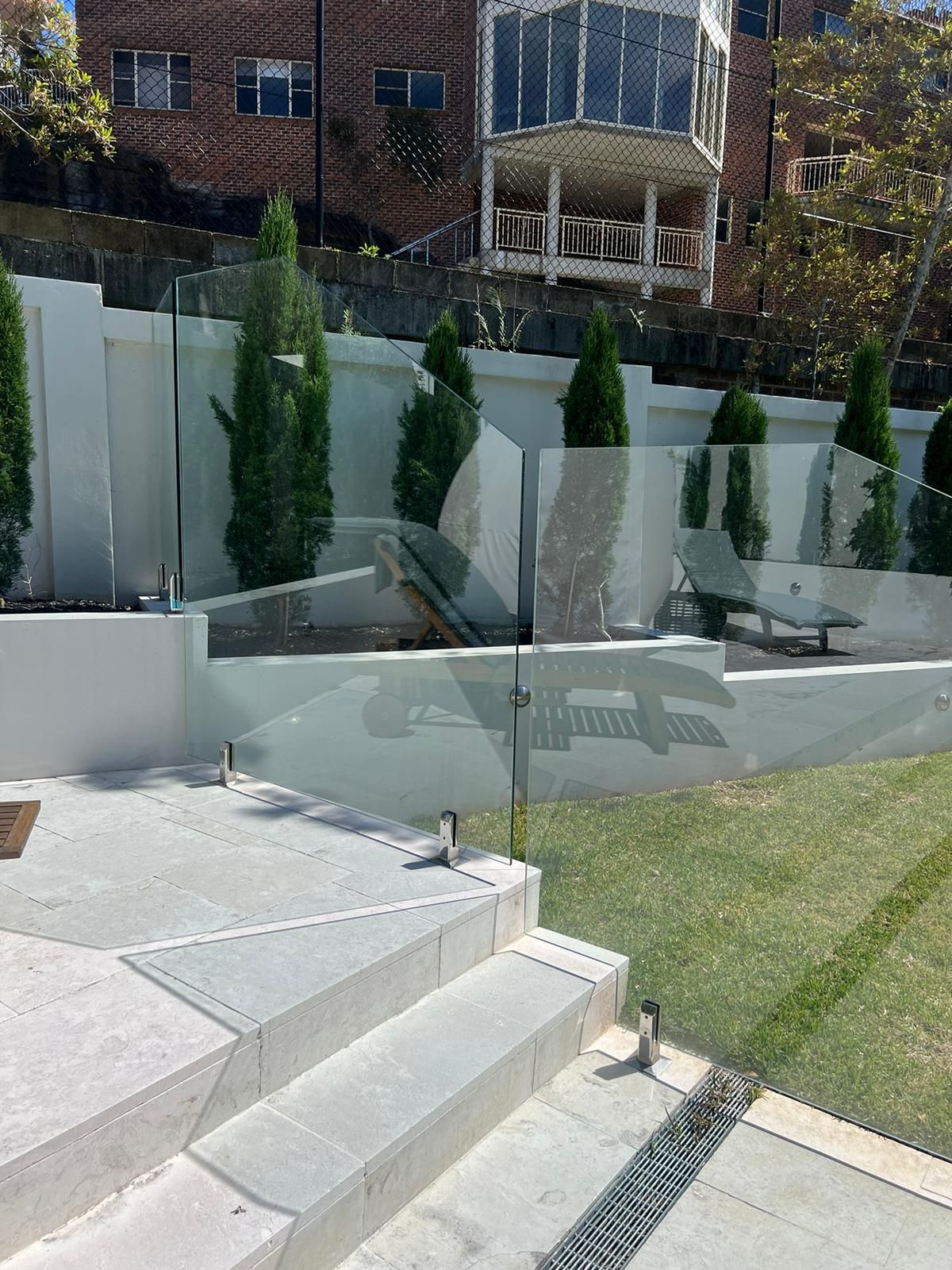 A Large House With a Swimming Pool in the Backyard Surrounded by Trees — Reflect Glass In Tuggerah, NSW