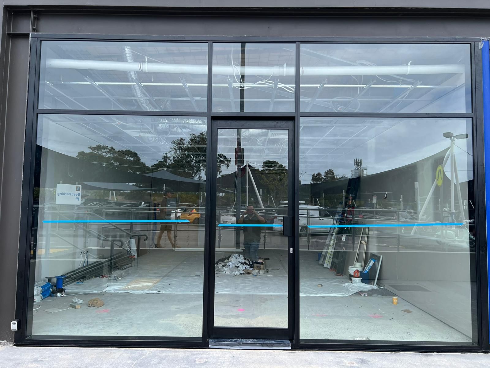 A Store Front With Black Awnings and Mannequins in the Window — Reflect Glass In Newcastle, NSW