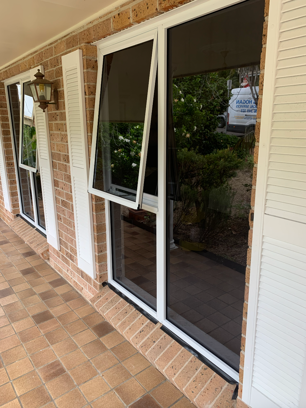 A Close Up of a Sliding Window With Trees in the Background — Reflect Glass In Lake Macquarie, NSW
