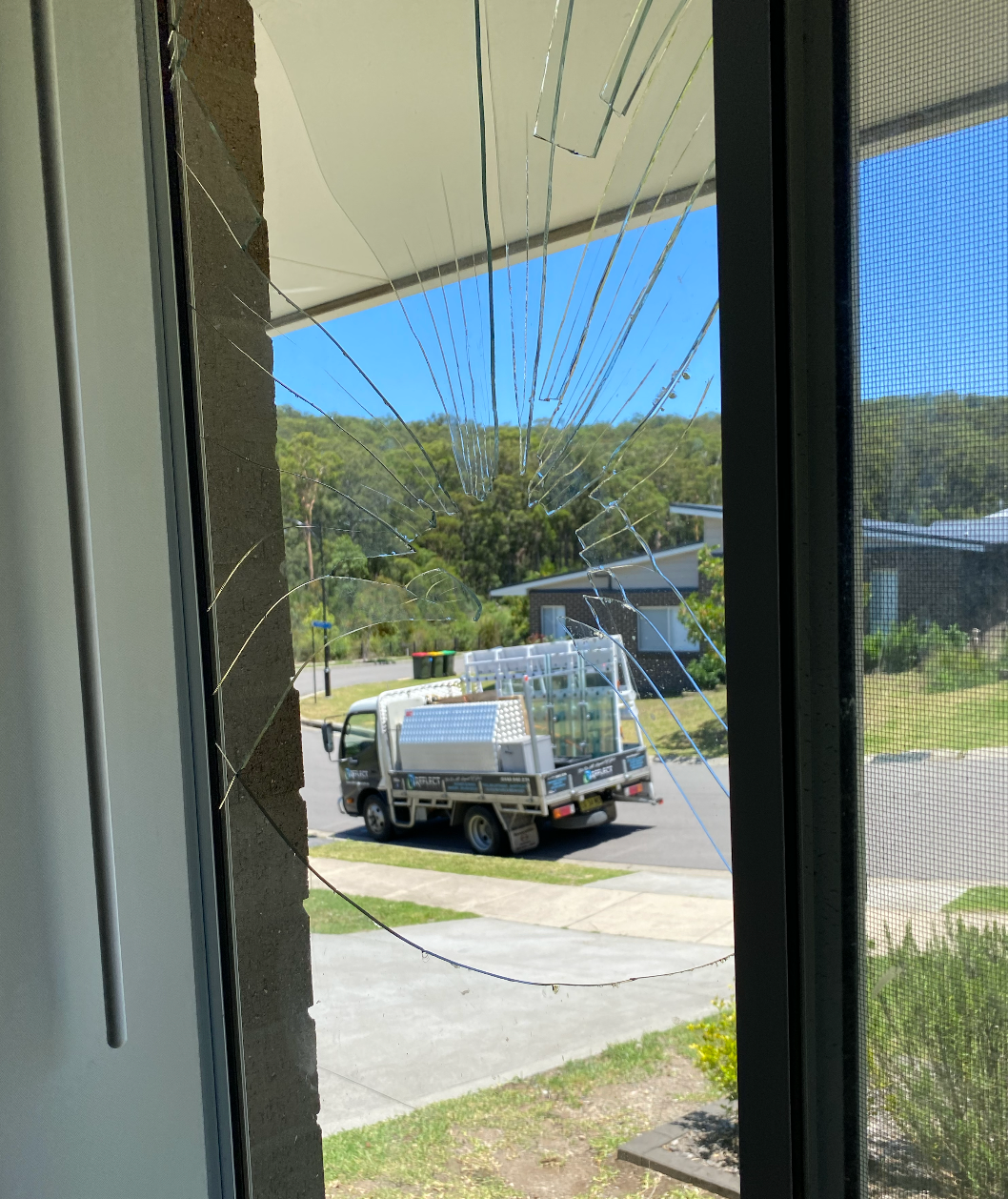 A truck is parked in front of a broken window — Reflect Glass In Tuggerah, NSW