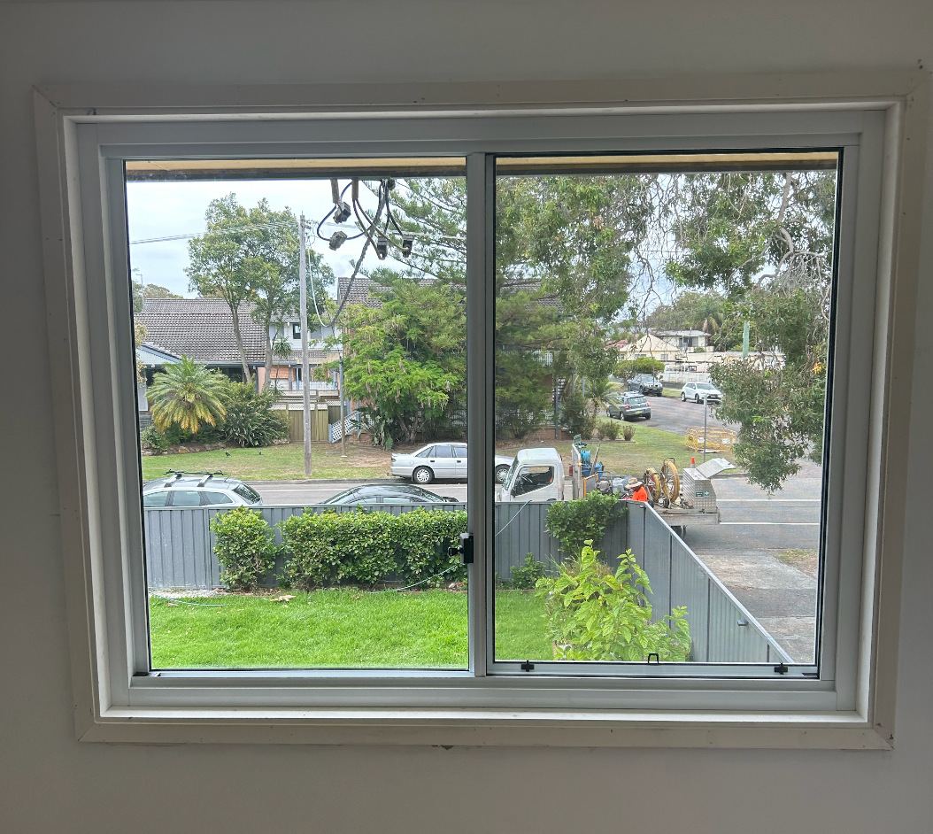 A Group of People Are Installing a Window — Reflect Glass In Tuggerah, NSW