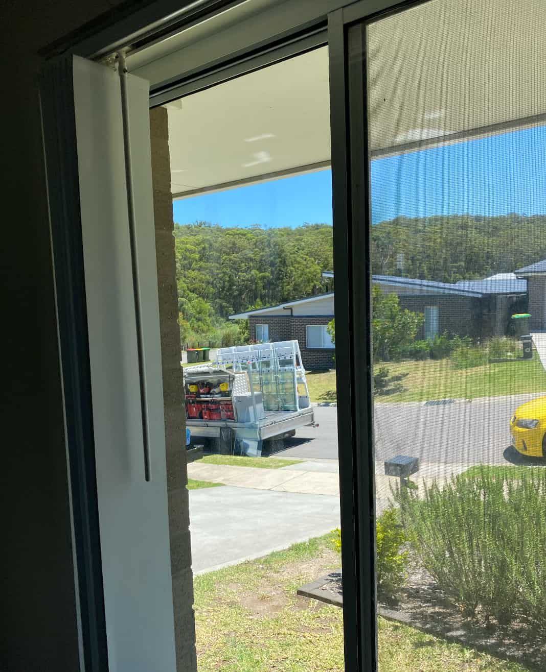 A Man Is Installing a Glass Window with Suction Cups — Reflect Glass In Gosford, NSW