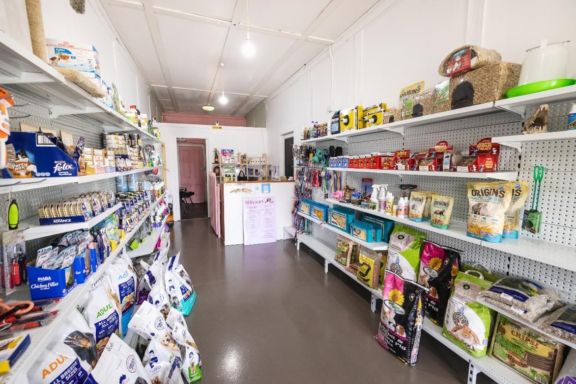 A Store Filled With Lots of Shelves and Bags of Food — Fluffy Paws Pet Grooming In Taree, NSW