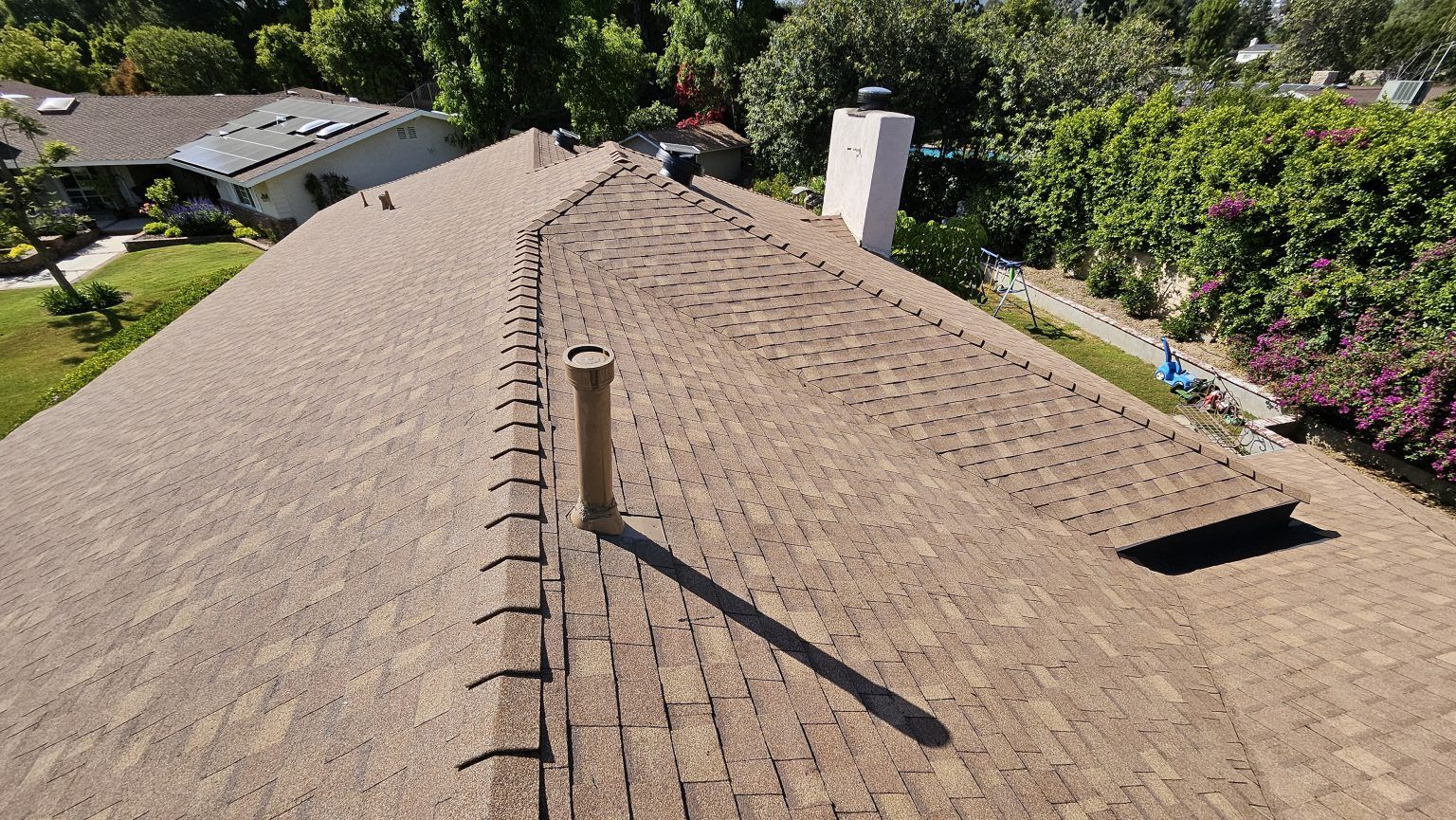 An aerial view of a roof with a chimney on it.