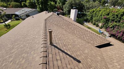 An aerial view of a roof with a chimney on it.
