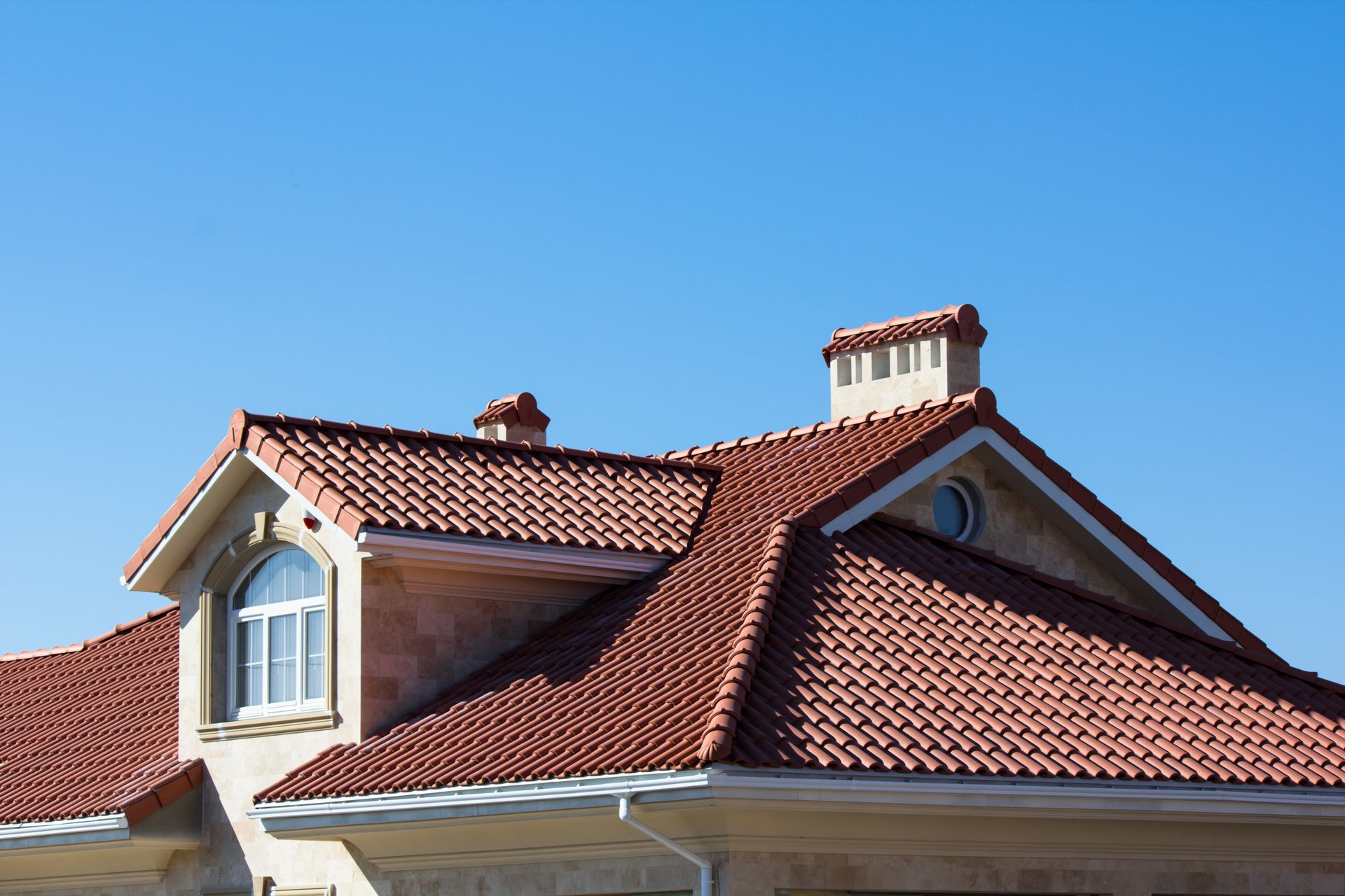 A house with a red tiled roof and a window.
