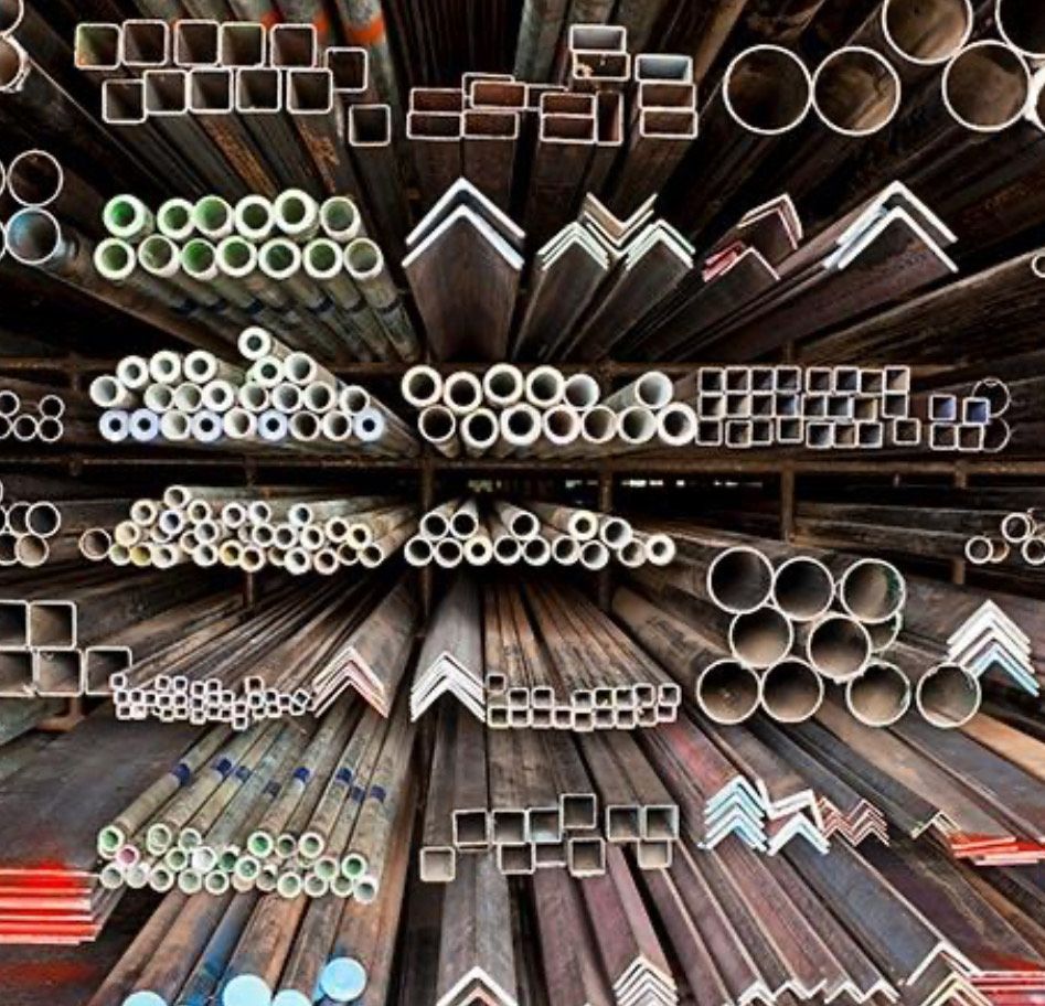 A Bunch Of Metal Pipes Stacked On Top Of Each Other