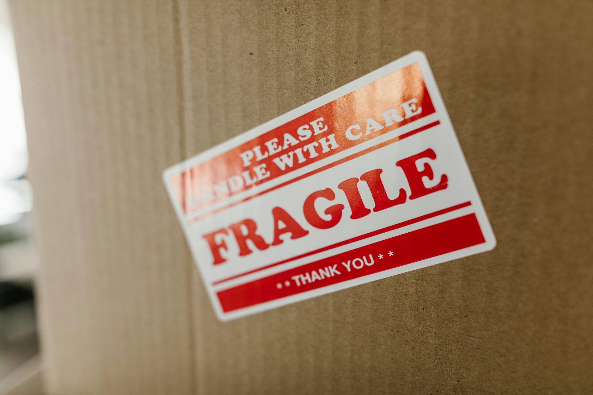 Close-up of a cardboard box with a red and white