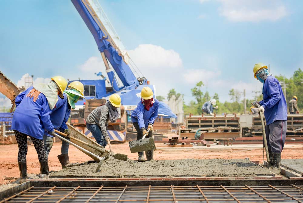 Concreter's Pouring Concrete Into Slab — AJ's Concreting Services in Taylors Beach, NSW