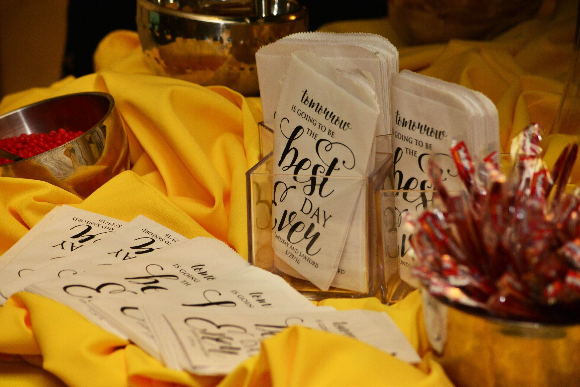 Wedding favor station with white bags that say
