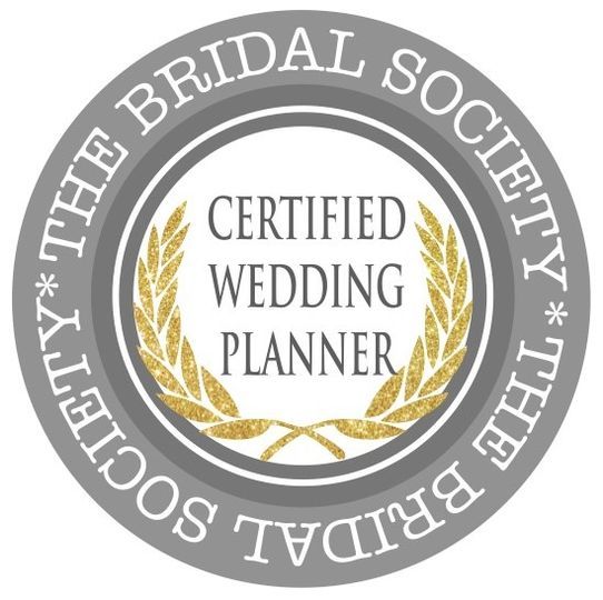 The Bridal Society certification badge with gold wreath, silver border, and
