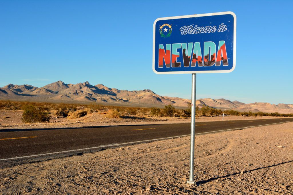 A sign on the side of a road that says Nevada