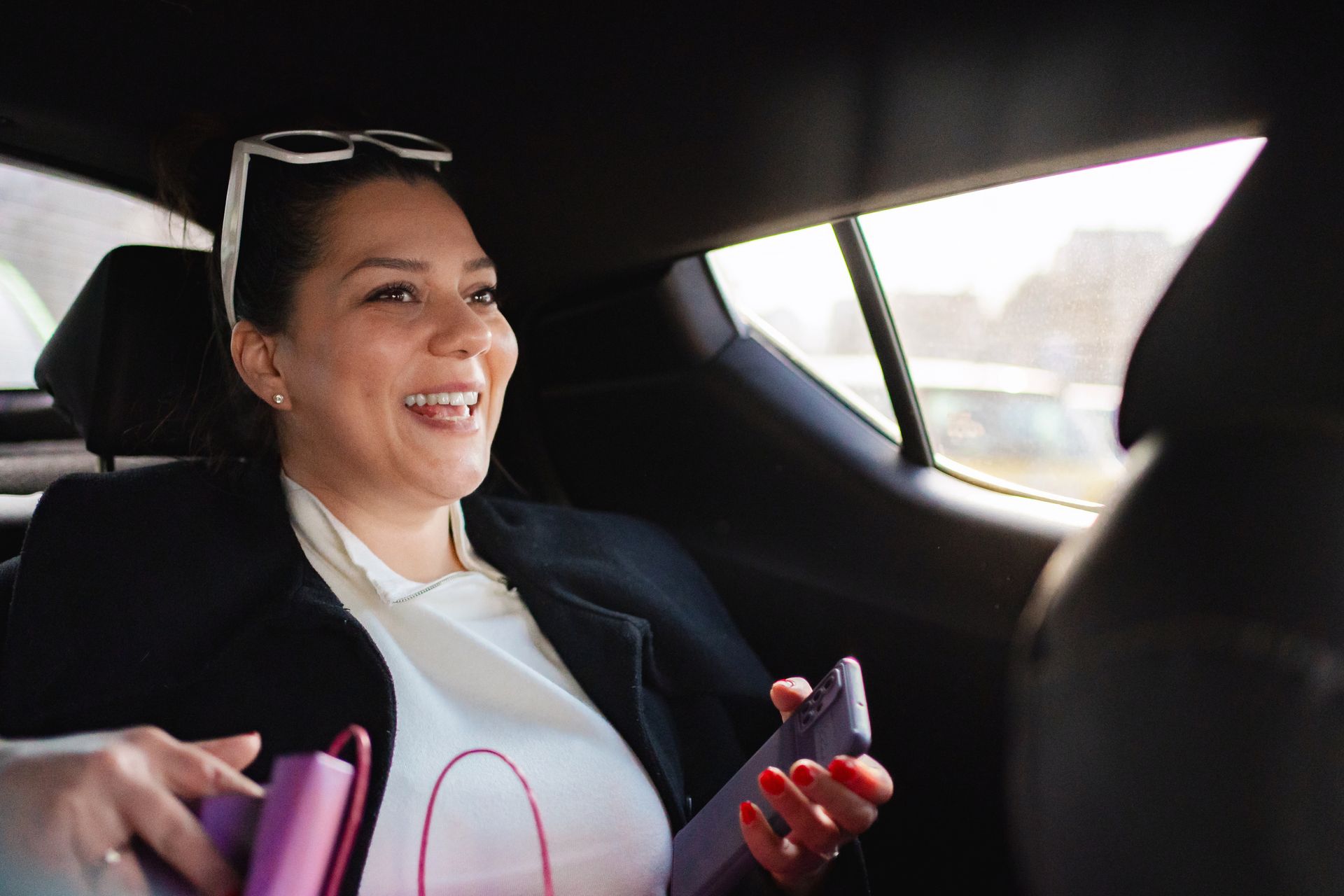 woman smiling in a rideshare car