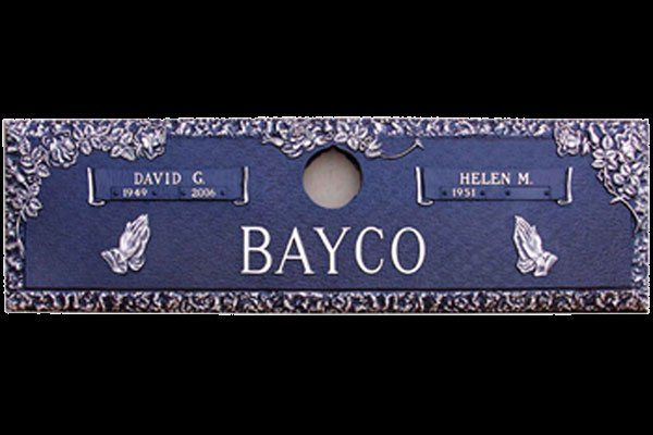 A blue grave marker for david and helen bayco