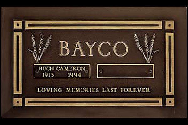 A brown and gold plaque with the name bayco on it