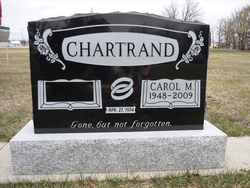 A black gravestone with the name chartrand on it