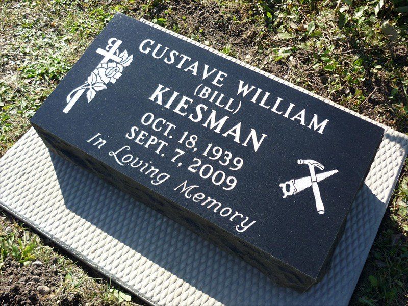 A black grave marker for gustave william kiesman