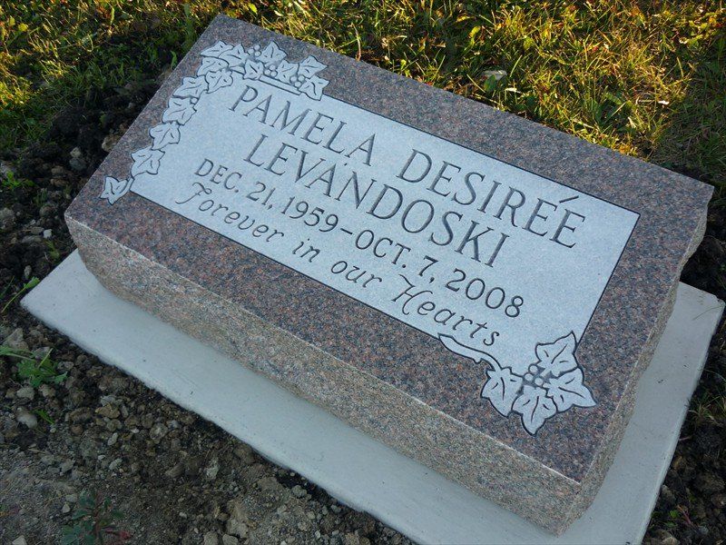 A gravestone for pamela desirree levandoski is sitting in a graveyard