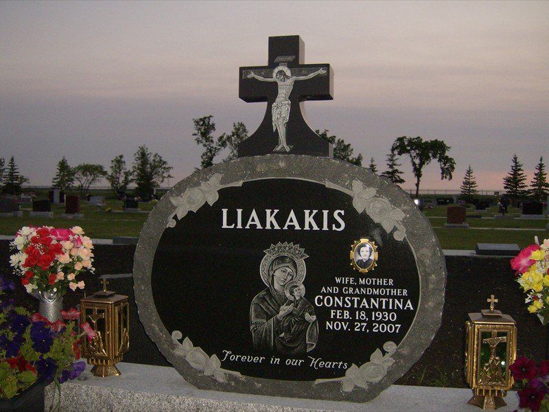 A gravestone in a cemetery with the name liakakis on it