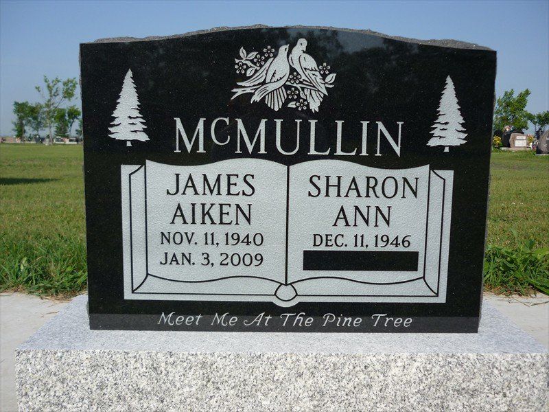 A gravestone for james aiken and sharon ann